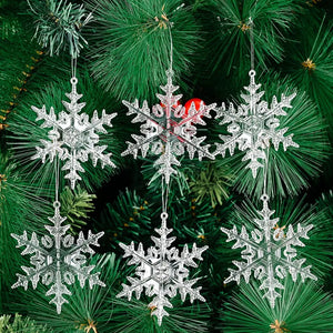 Crystal snowflake ornaments hang on a Christmas tree.