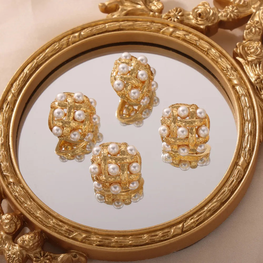 Gold woven pearl grid earrings with a textured finish and cubic shape.