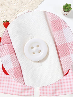 Pink gingham toddler dress with white button detail and fruit appliqué.