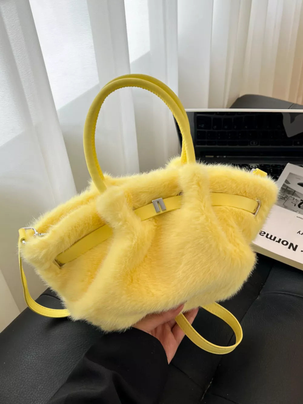 Yellow plush crossbody bag with chic buckle detail and top handles