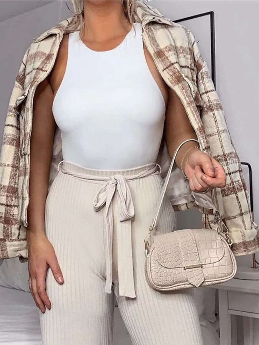 White round neck sleeveless bodysuit with a comfortable fit