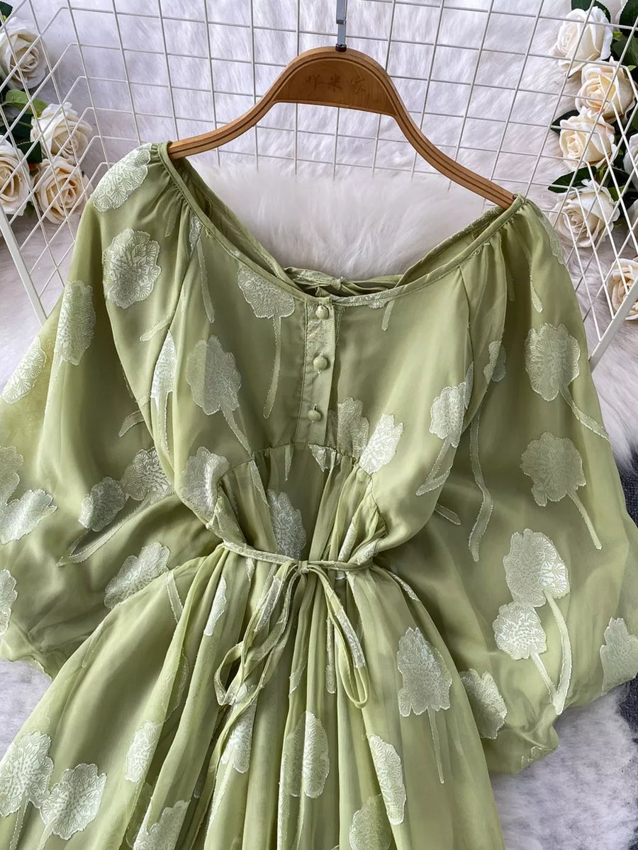Green chiffon maxi dress with floral embroidery, button front, and tie waist.