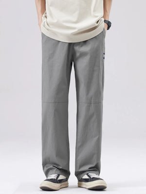 Men's casual grey wide-leg sweatpants with a relaxed fit and subtle logo detail.