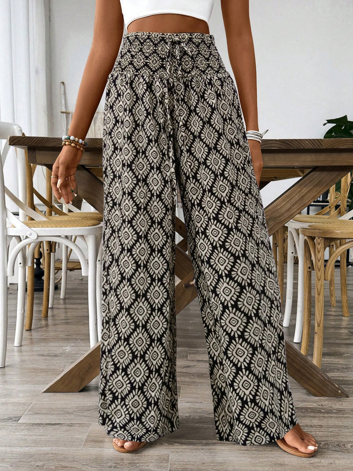 Geometric print wide leg pants in black and white with a drawstring waist.