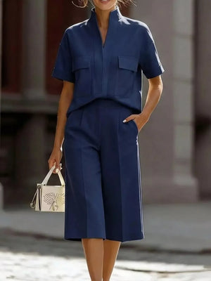 Dark blue two-piece set with pocketed top and wide-leg pants.