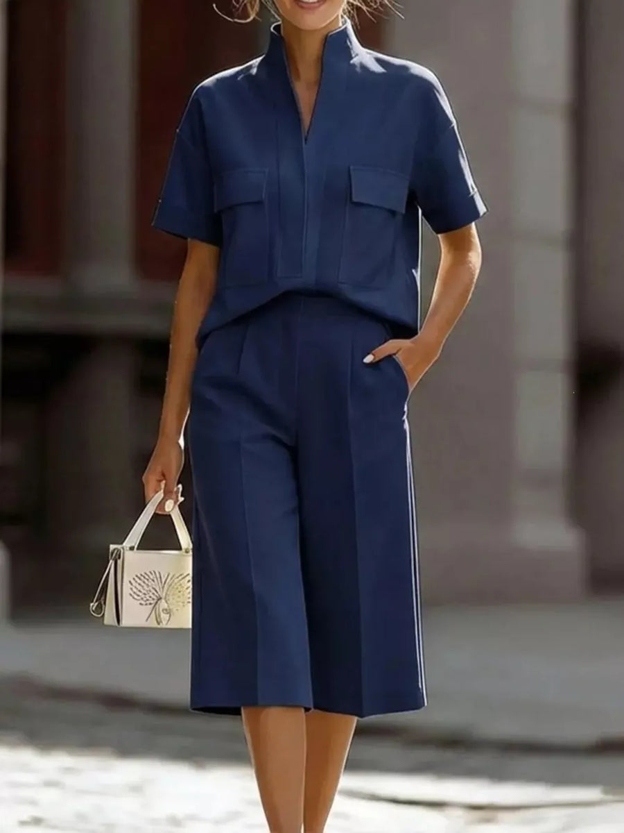 Dark blue two-piece set with pocketed top and wide-leg pants.