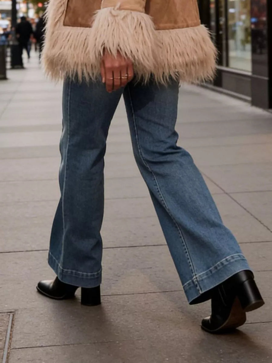 Baby girls' blue denim flare jeans with button closure and wide leg opening.
