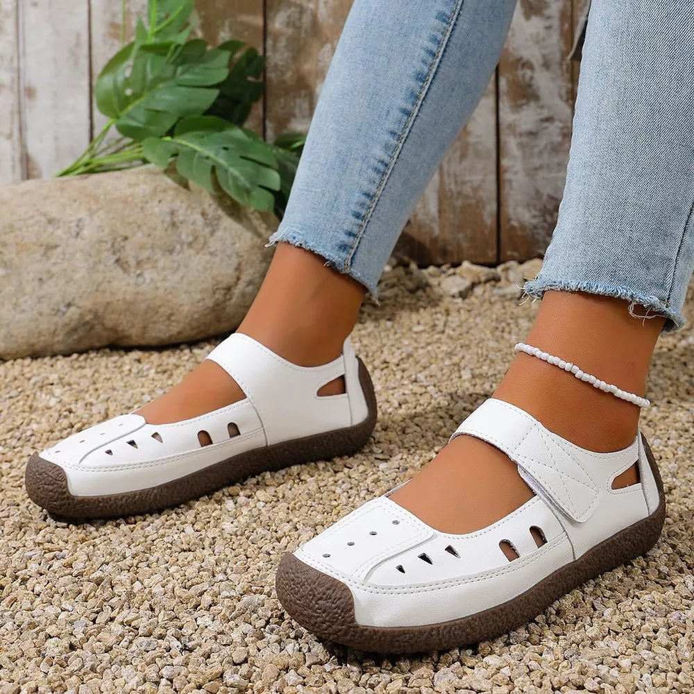 White round toe platform flats with cutouts and adjustable strap.