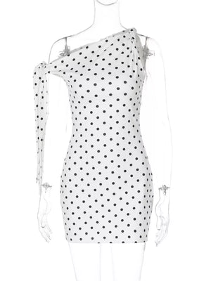 White polka dot mini dress with asymmetrical neckline and bow detail on one shoulder.