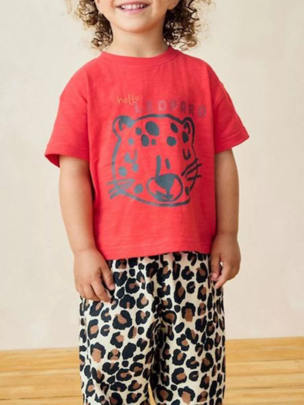 Red cotton toddler t-shirt with leopard graphic and text.