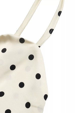 Cream polka dot maxi dress with tie detail and cutout.