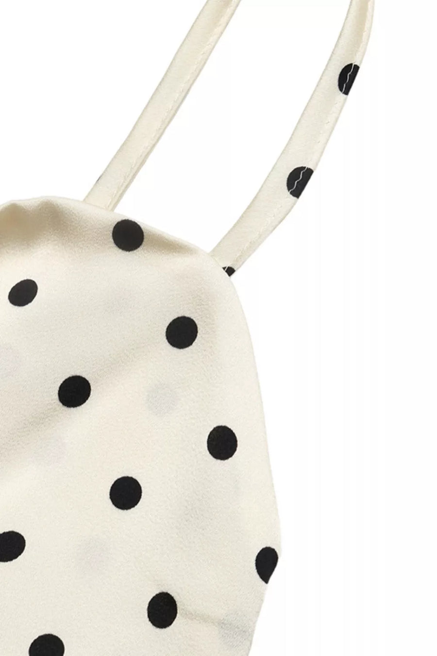 Cream polka dot maxi dress with tie detail and cutout.