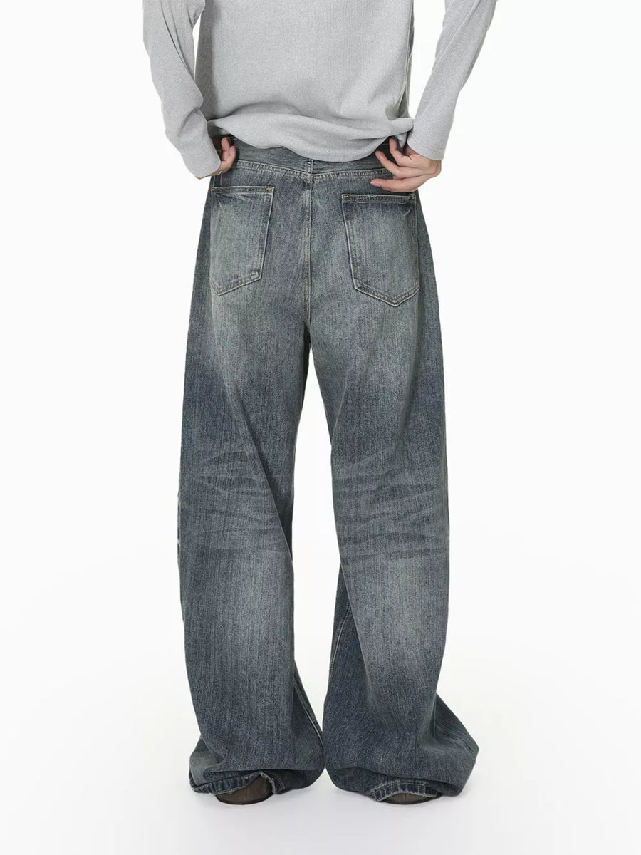 Men's wide leg denim jeans in washed blue with a relaxed fit.
