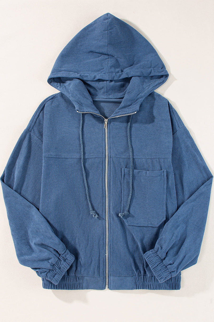 Dusty blue corduroy bomber hoodie with zip front, drawstring hood, and chest pocket.