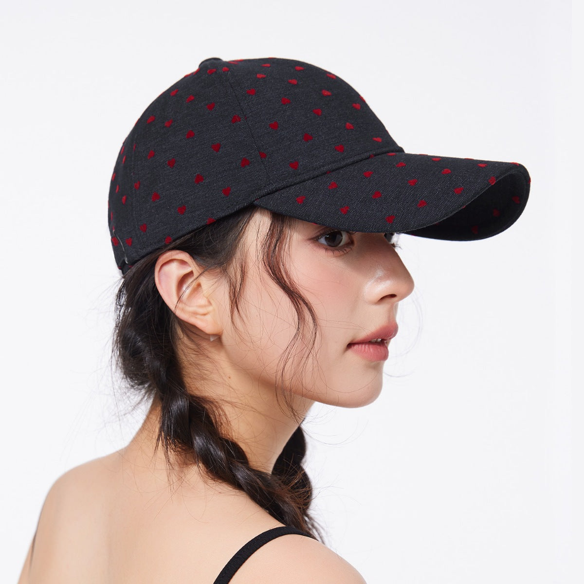 Black baseball cap with red heart pattern, blended fabric