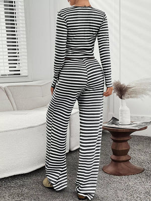 Black and white striped loungewear set with long sleeves and wide-leg pants.