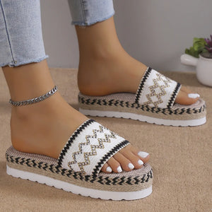 Embroidered platform espadrille slides in white with black trim and zigzag detail.