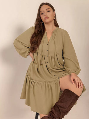 Olive green button-front tie-neck dress with balloon sleeves and tiered skirt.