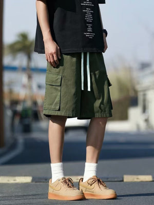 Men's green cargo shorts with drawstring and button-flap pockets.