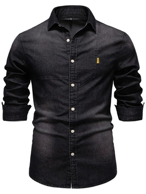 Dark denim button-down shirt with asymmetric pocket detail and rolled sleeves.