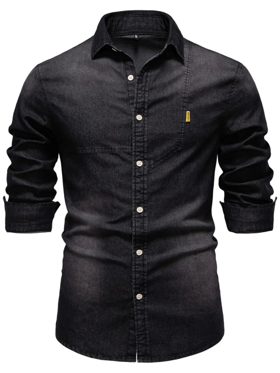 Dark denim button-down shirt with asymmetric pocket detail and rolled sleeves.