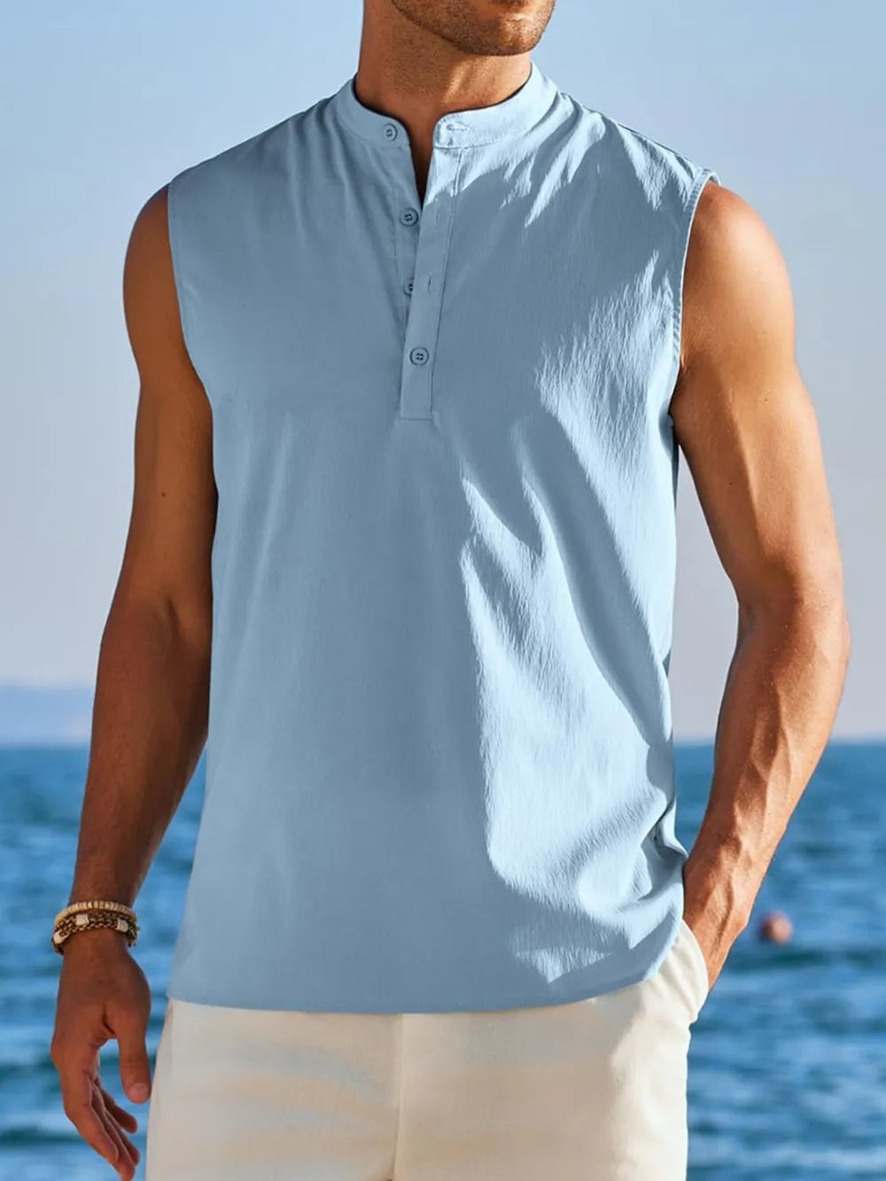Light Blue sleeveless Mandarin collar shirt with buttoned placket and subtle pleat detail.