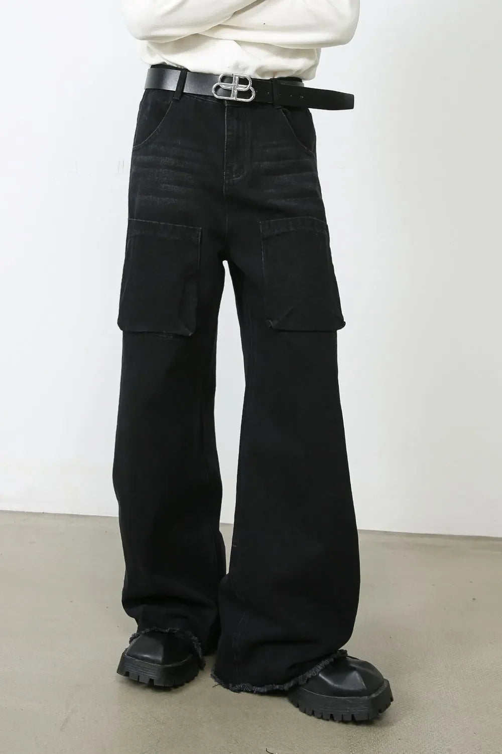 Dark denim cargo pants with wide legs and large front pockets.