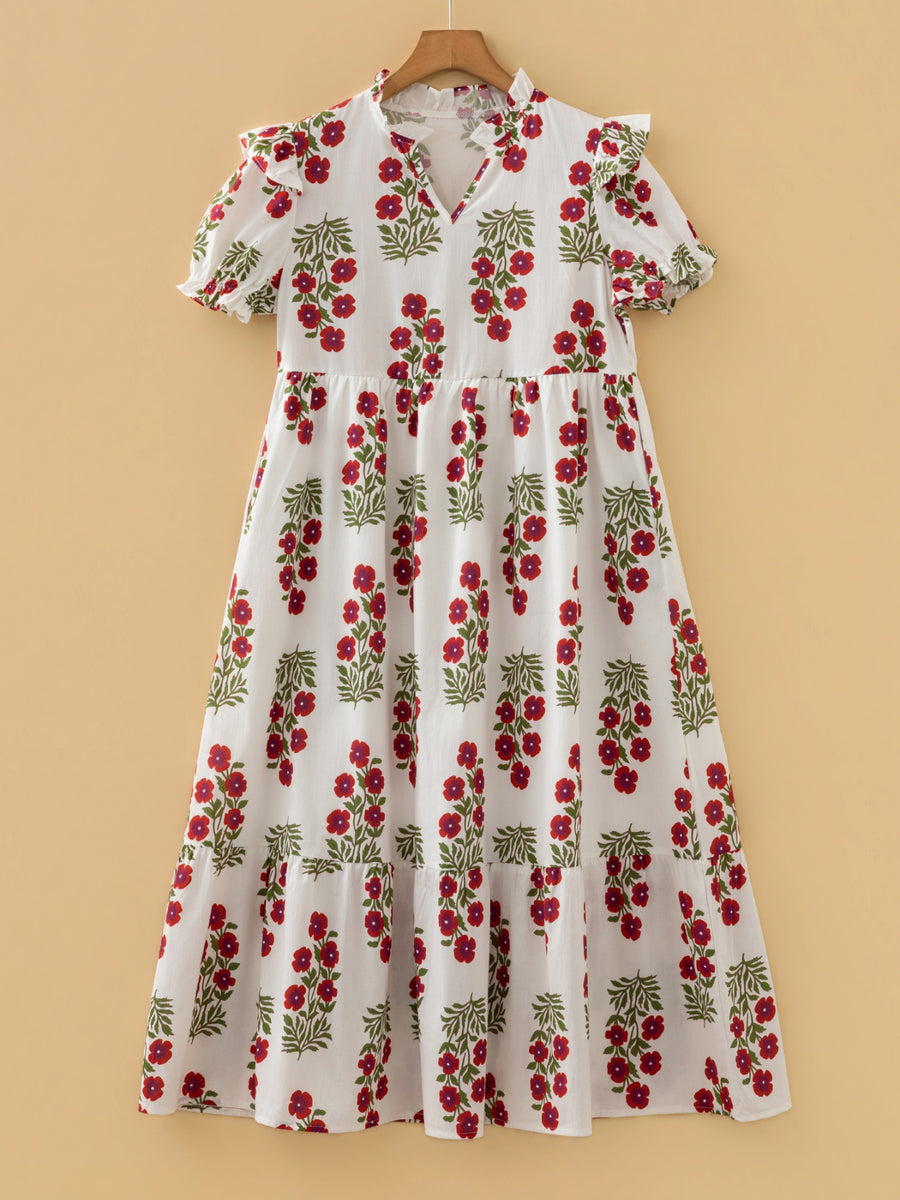 V-neck mini dress with pockets in white with red floral print, short sleeves, and tiered skirt.