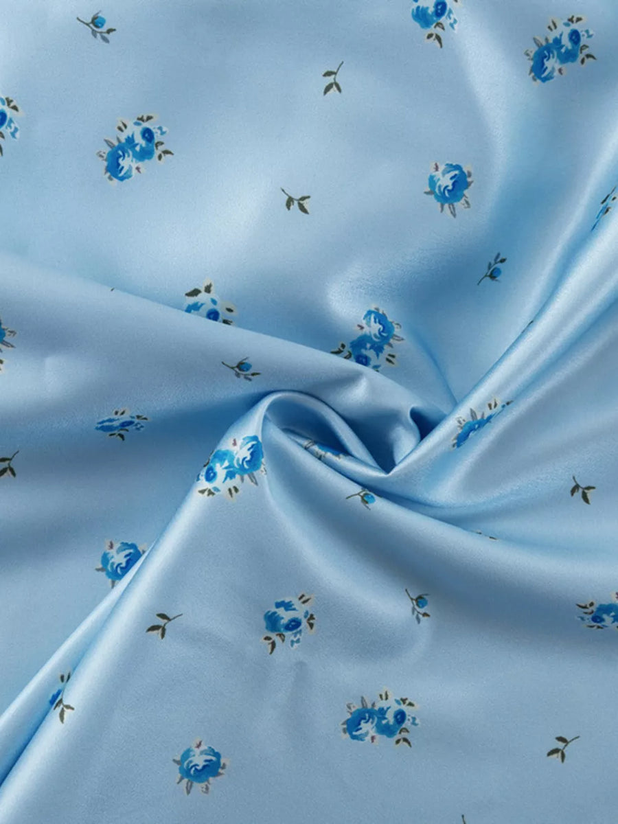 Light blue satin fabric with a small blue floral print