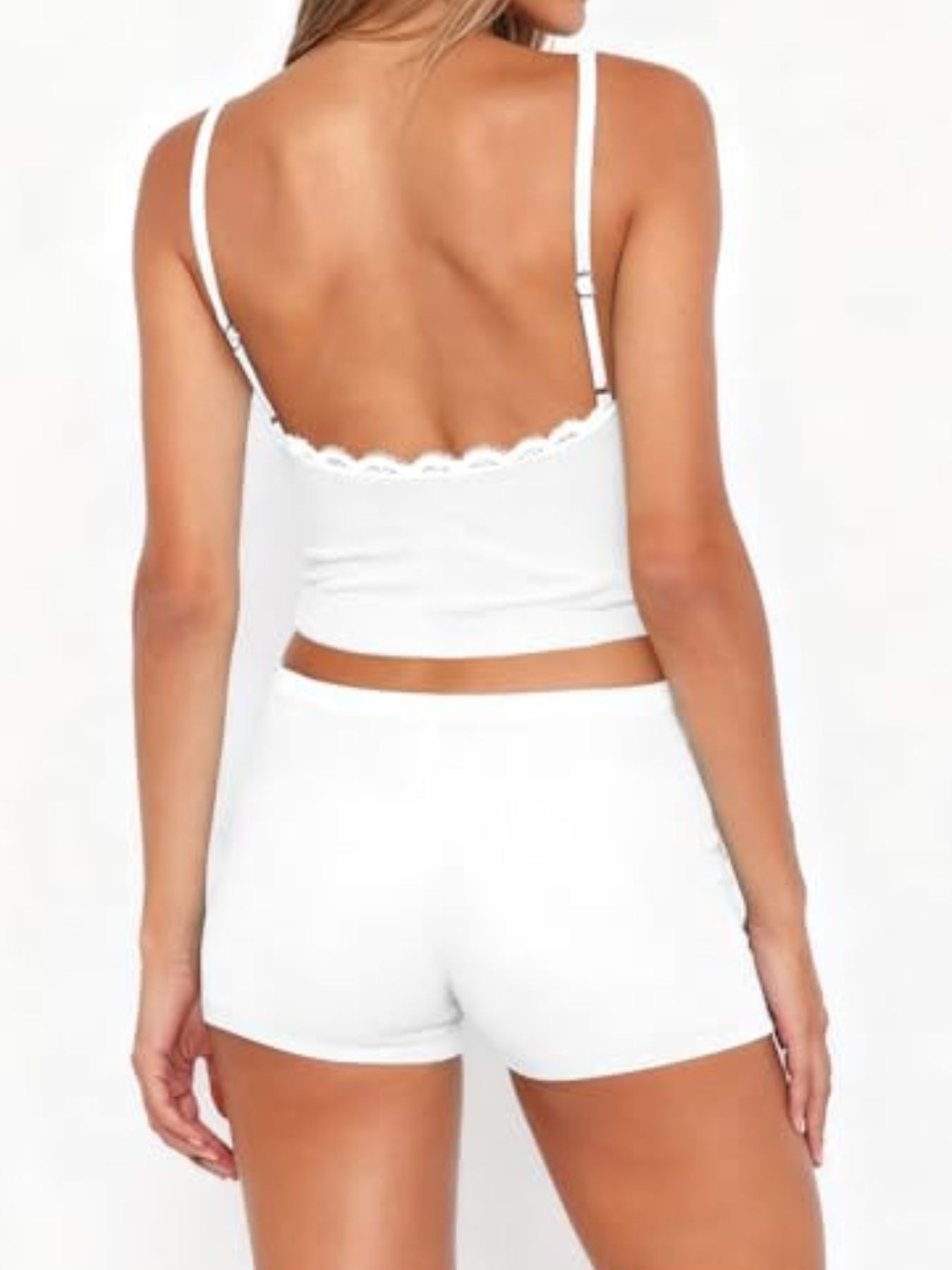 White lace-trimmed cami and shorts pajama set with adjustable straps.