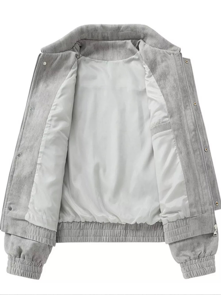 Grey corduroy trucker jacket with white lining and elastic cuffs and hem.