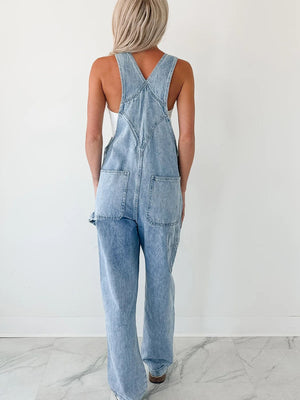 Light wash denim overalls with wide straps, relaxed fit, and back pockets.