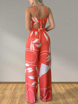 Orange tropical print crop top and wide-leg pants set with tie-back detail.