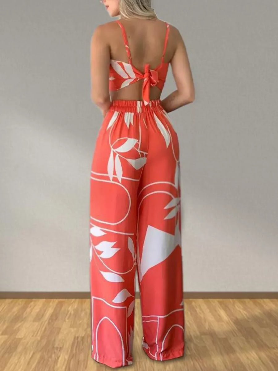 Orange tropical print crop top and wide-leg pants set with tie-back detail.