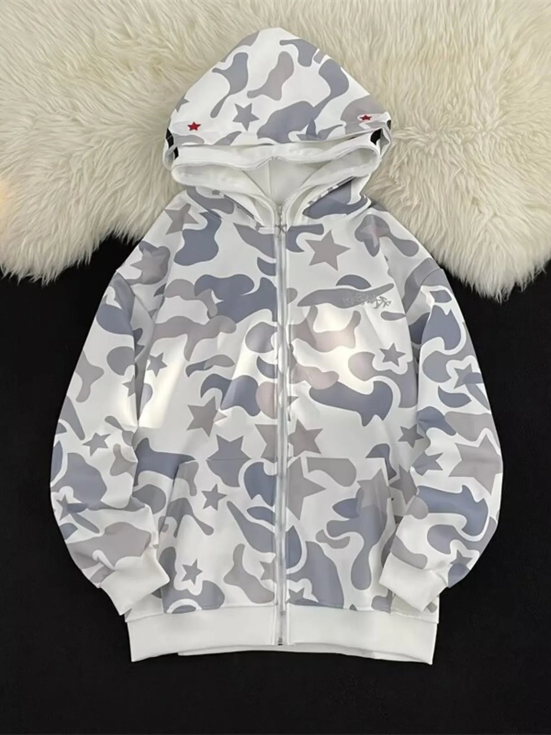 Off-white camo print zip-up hoodie with stars and red accents on the hood.