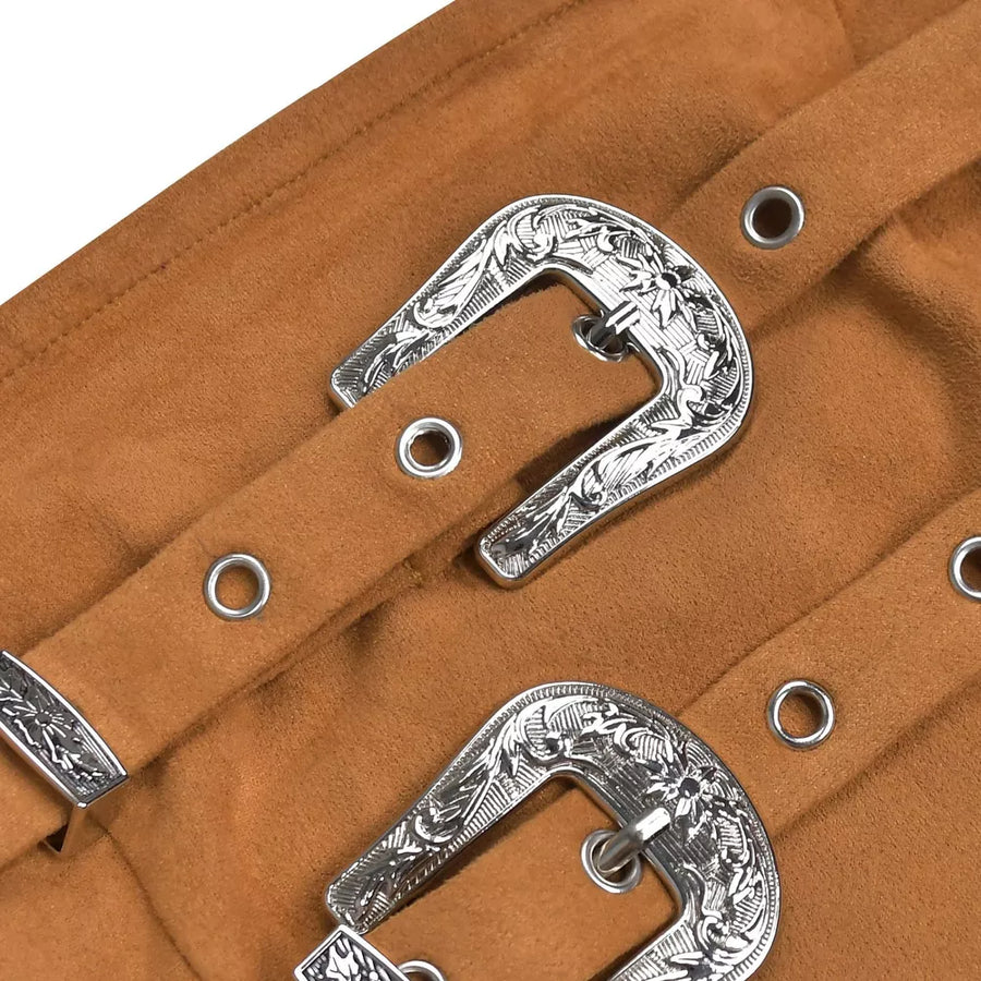 Caramel suede dress detail with ornate silver buckle accents and grommets.