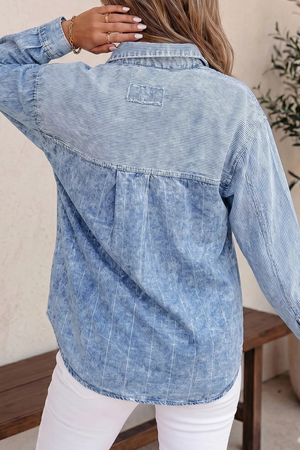 white button-down shirt featuring buttoned and striped