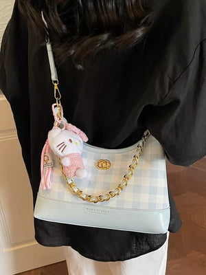 Pastel blue plaid shoulder bag with chain accent and Hello Kitty charm