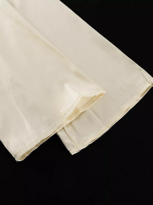 Cream wide leg pants with a smooth finish and clean hem