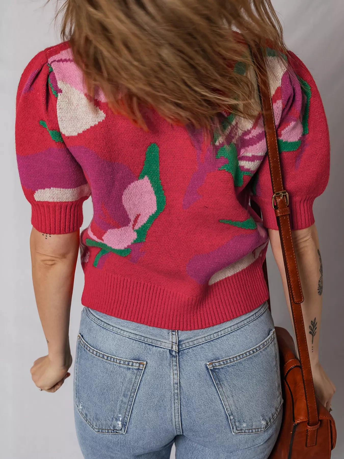 Scarlet abstract floral puff sleeve sweater with ribbed cuffs and hem.