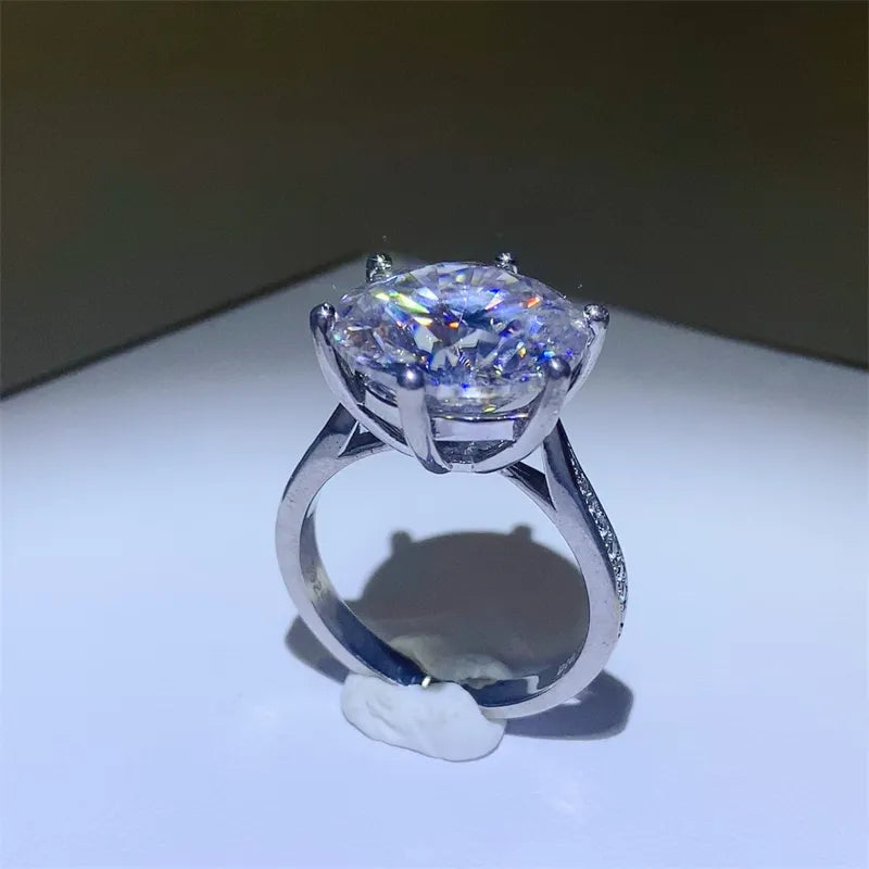 Silver engagement ring with large round-cut diamond and pave band.