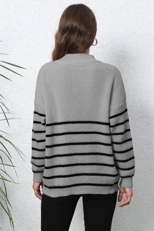 Gray knit sweater with black horizontal stripes and a mock neck.