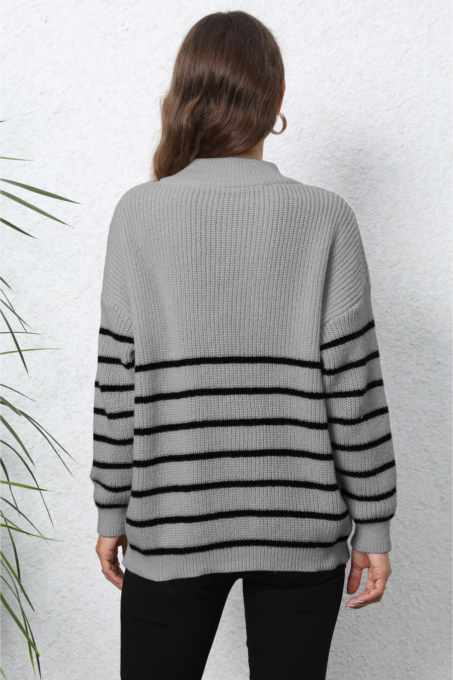 Gray knit sweater with black horizontal stripes and a mock neck.