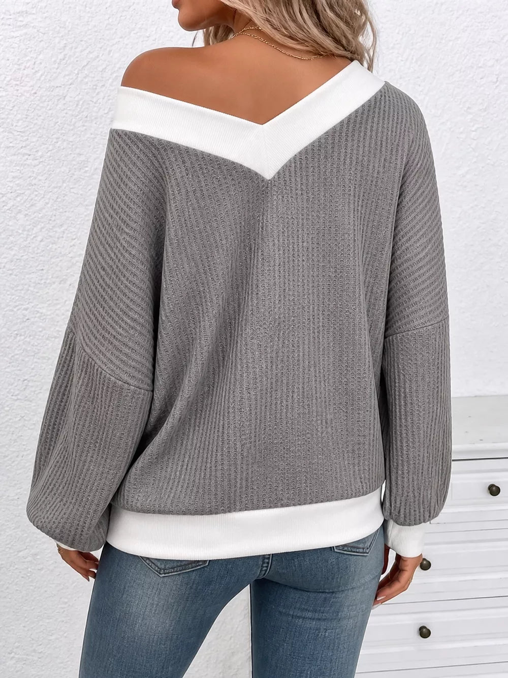 95% polyester, 5% elastane Care instructions: Machine wash cold v-neck sweater in white with relaxed silhouette