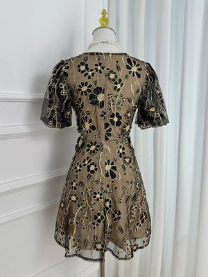 Black floral embroidered mesh dress with puff sleeves and a tan lining.