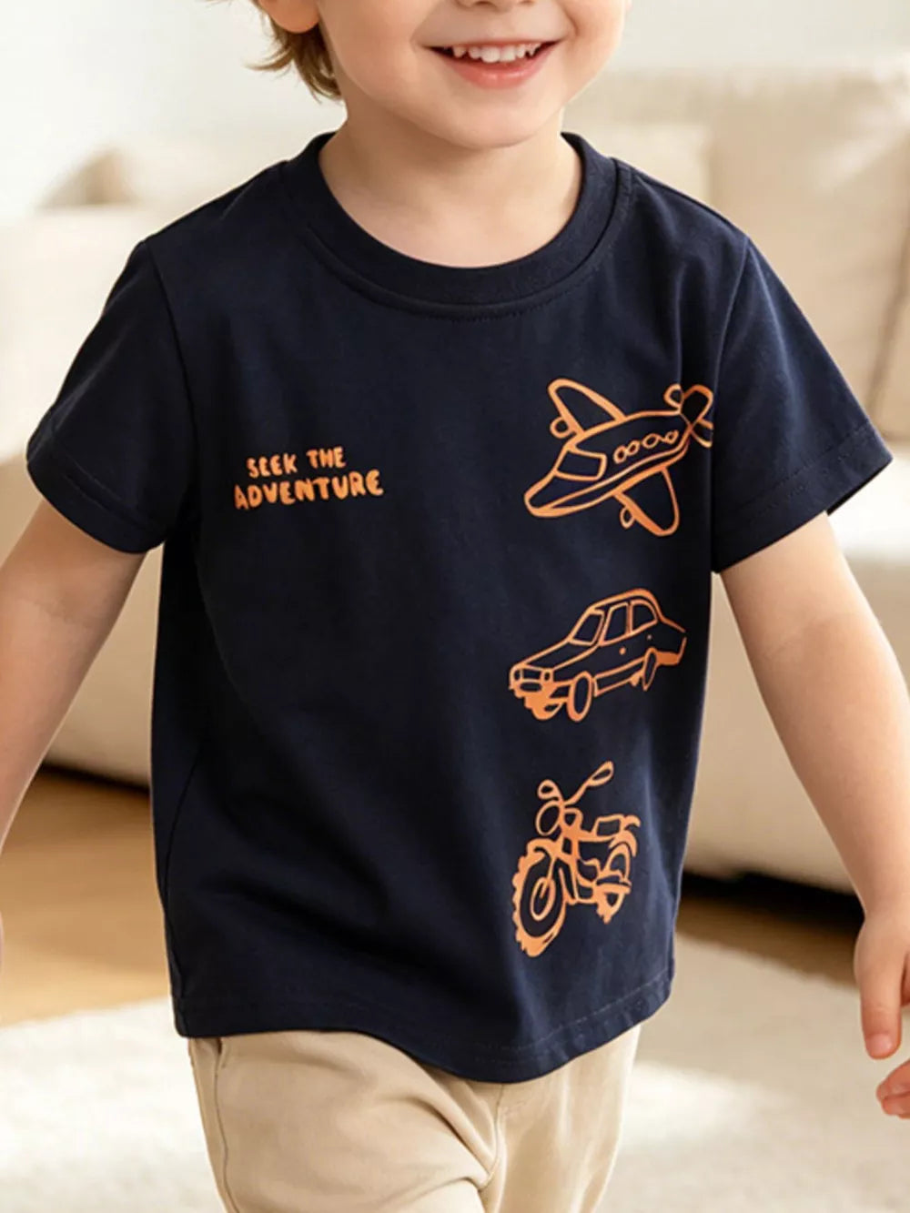 Navy t-shirt with orange airplane, car, and motorcycle graphic and text