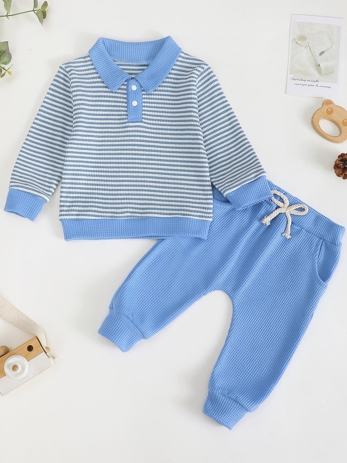 Children's blue and white striped polo shirt and blue waffle knit pants set.