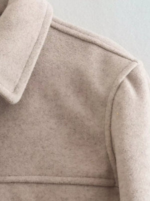 Beige trucker jacket with collared neckline and visible stitching detail.