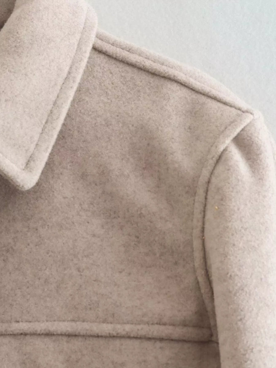 Beige trucker jacket with collared neckline and visible stitching detail.