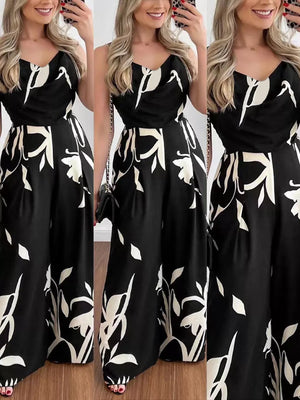 Black abstract leaf print wide-leg jumpsuit with cinched waist and adjustable straps.